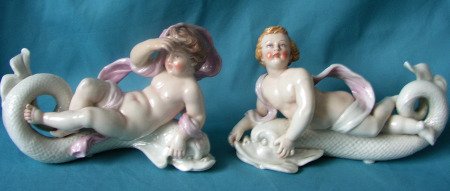 A Pair of Royal Worcester Figures of putti and dolphins c.187 A Pair of Royal Worcester Figures of putti and dolphins c.187